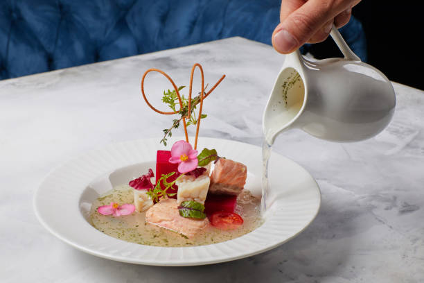 istock fish soup decorated with flowers, in which broth is poured 1354825327