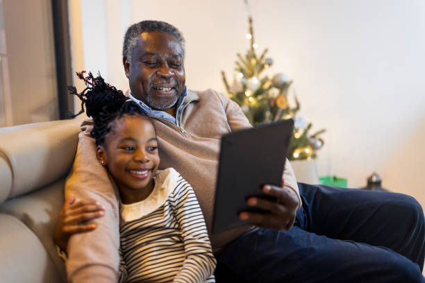 Girl having video call with grandfather stock photo