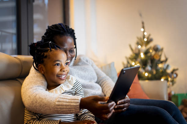 istock Mother and daughter having a Christmas video call 1354825385