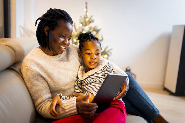 istock Mother and daughter having a Christmas video call 1354825387