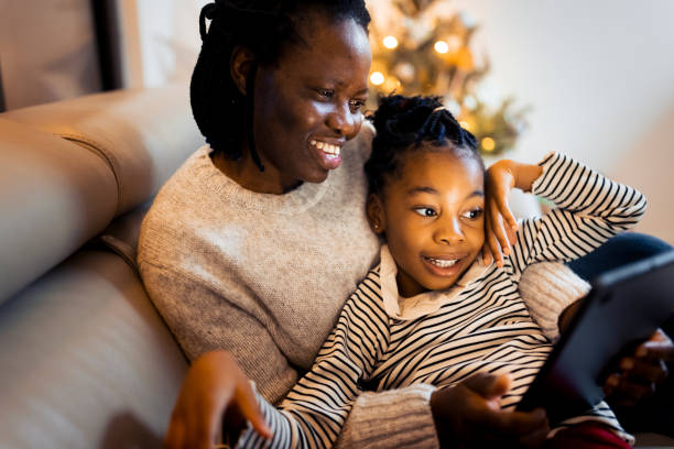 Mother and daughter having a Christmas video call stock photo