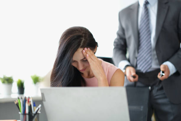 istock Woman office worker closing face feeling ashamed because of her boss harassment 1354828982