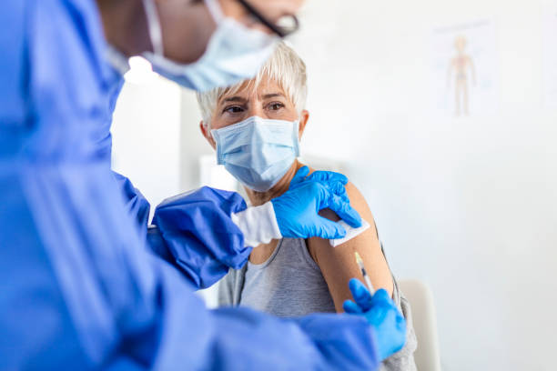 istock Covid-19 Vaccination. Senior Patient Getting Vaccinated Against Coronavirus Receiving Covid Vaccine Intramuscular Injection During Doctor's Appointment In Hospital. Corona Virus Immunization 1354829135