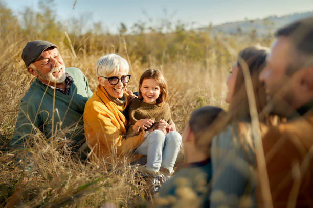 istock Happy extended family enjoying while talking in autumn day on a hill. 1354831335