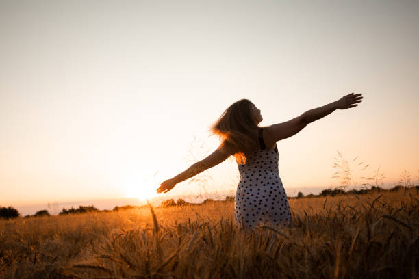 istock Woman Standing On Field Against Sky During Sunset 1354832034