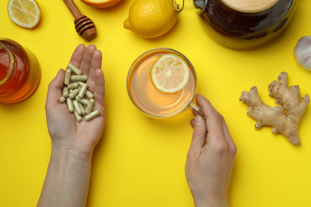 istock Female hands and alternative medicines on yellow background, top view 1354833796