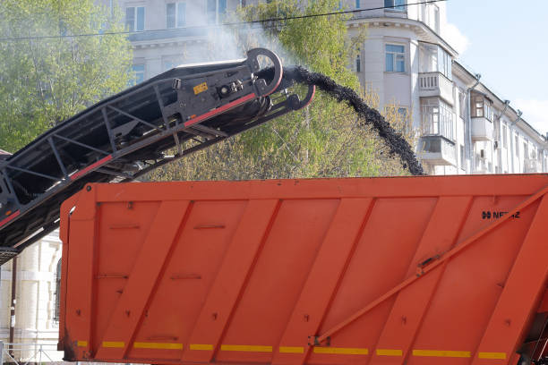 istock Pavement removing machine loads old asphalt into dumptruck 1354833904