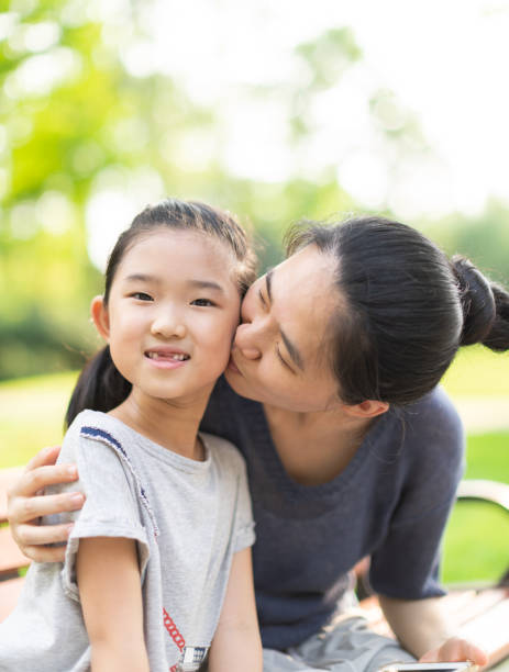 istock Mother kissing daughter 1354835294