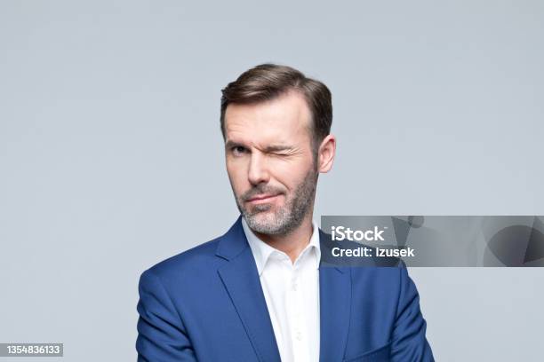 Headshot Of Cheerful Mature Businessman Stock Photo - Download Image Now - Winking, Men, Portrait