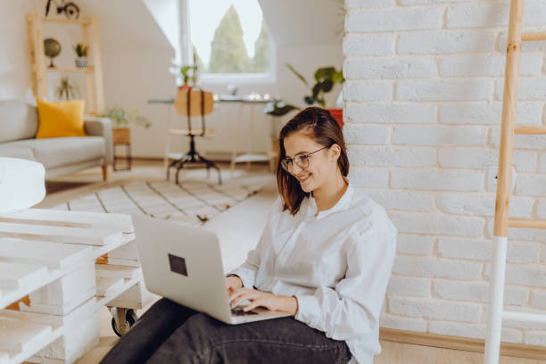 istock Happy young Woman in her Home Office and Using her Laptop 1354836349
