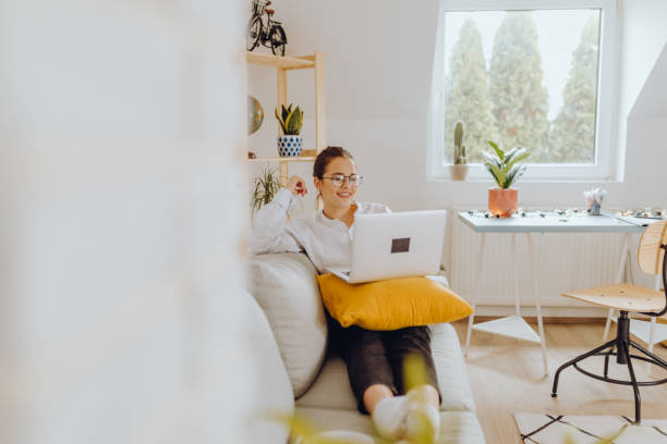 istock Happy young Woman in her Home Office and Using her Laptop 1354836511