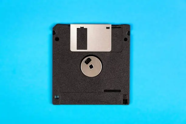 Floppy Disk Drive on the Blue Paper Background closeup