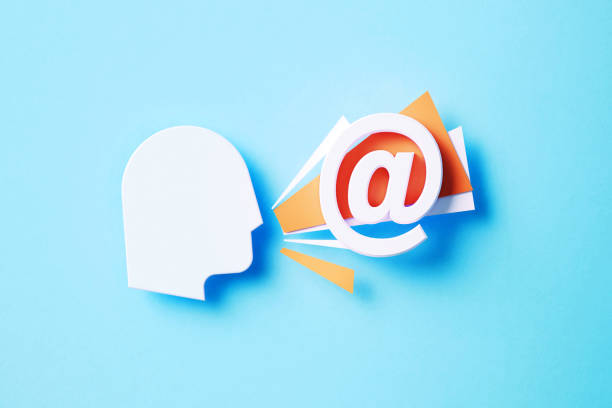 istock At Symbol Sitting Next To Human Head On Blue Background 1354837803