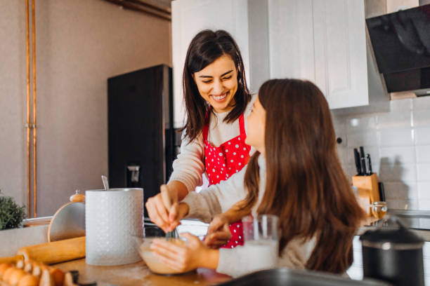 istock Mom with daughter on kitchen 1354837976