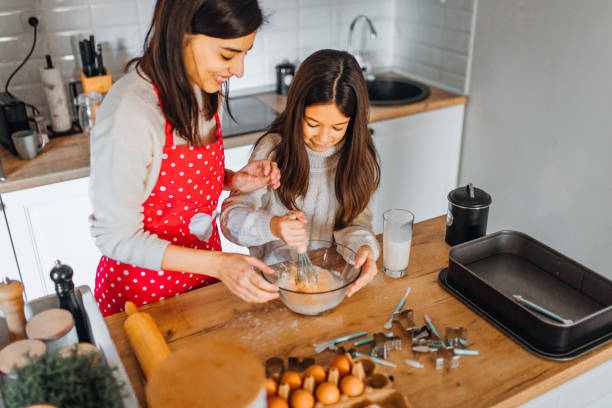 istock Mom with daughter on kitchen 1354838051
