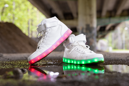 White sneakers with colorful LED lights in soles
