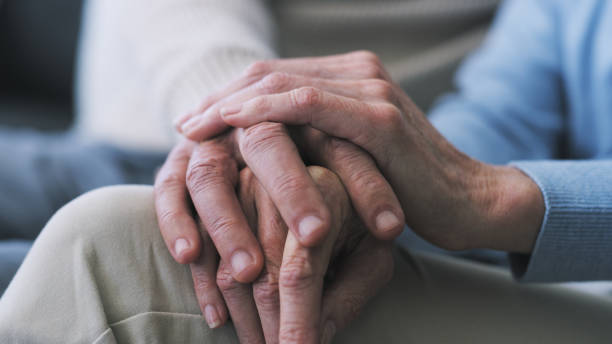 istock Cropped shot of an older unrecognizable couple holding hands at home 1354840407