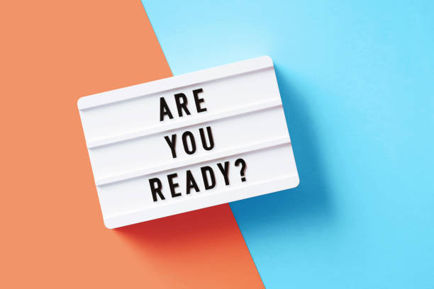 istock Are You Ready Written White Lightbox Sitting On Pink And Blue Background 1354840880