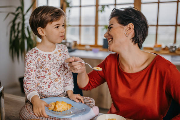 istock Mother and daughter having breakfast 1354840982