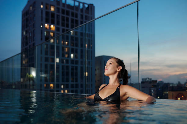istock Pensive Woman Relaxing in Swimming Pool 1354841285