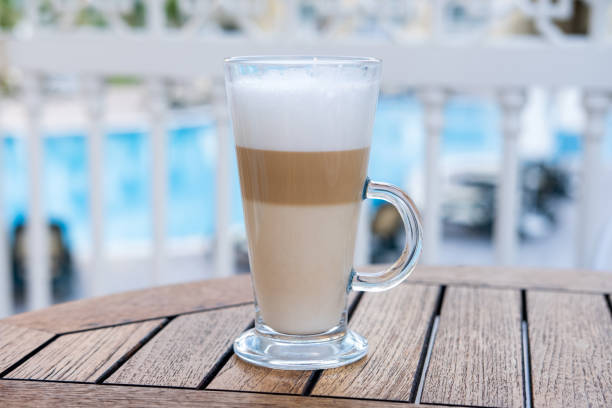 istock A latte coffee in a glass mug is on a table in a cafe. 1354841434