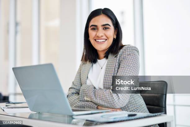 Portrait Of A Young Businesswoman Working On A Laptop In An Office Stock Photo - Download Image Now