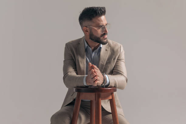 istock serious businessman looking to the side, rubbing his palms 1354843552
