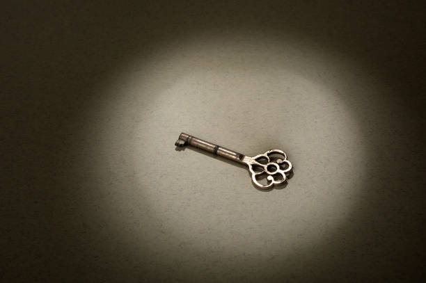 istock Old vintage key on paper background. 1354843994