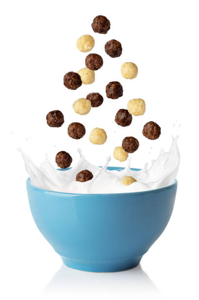 vanilla and chocolate corn balls falling in blue bowl - yoghurt chocolate bowl bildbanksfoton och bilder