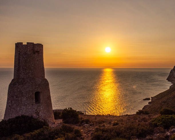 istock Sunrise by the watchtower. 1354845037