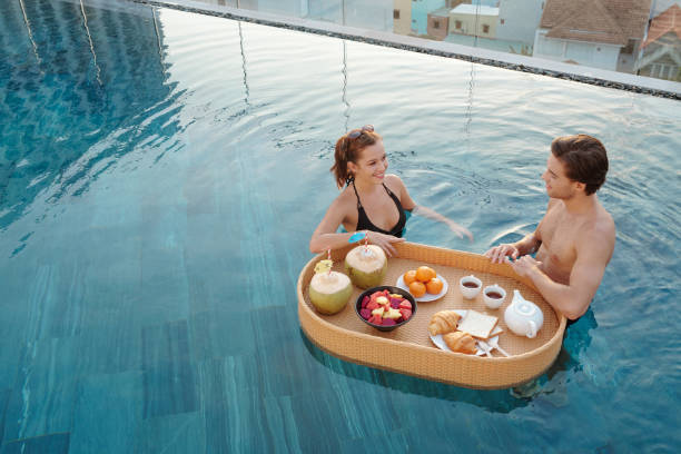 istock Couple Having Breakfast in Outdoor Pool 1354845050