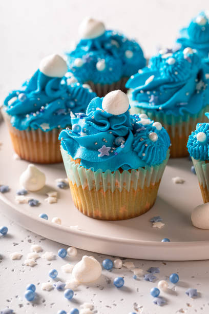 istock Homemade cupcakes with white sprinkles and blue cream. 1354847301