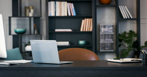 Shot of a laptop in an empty office stock photo