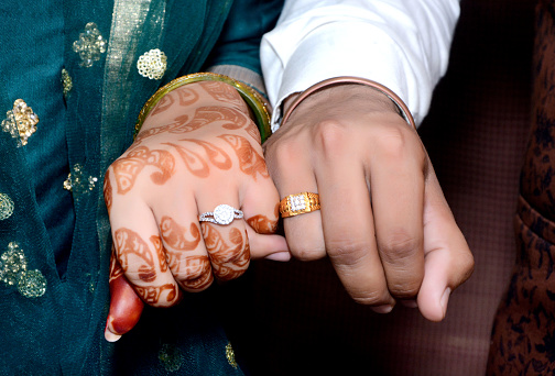 The bride and groom hands holding & showing wedding Jewelry Rings