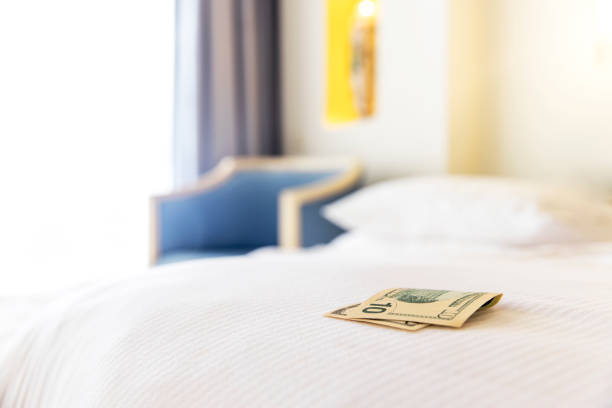 Traditional tips is laying on the corner of bed in hotel room for room cleaner Traditional tips is laying on the corner of the bed in hotel room. Dollar or euro money tips to thank the room cleaner for good service. Grateful vacationers at the Egypt resort. High quality photo corner tip stock pictures, royalty-free photos & images