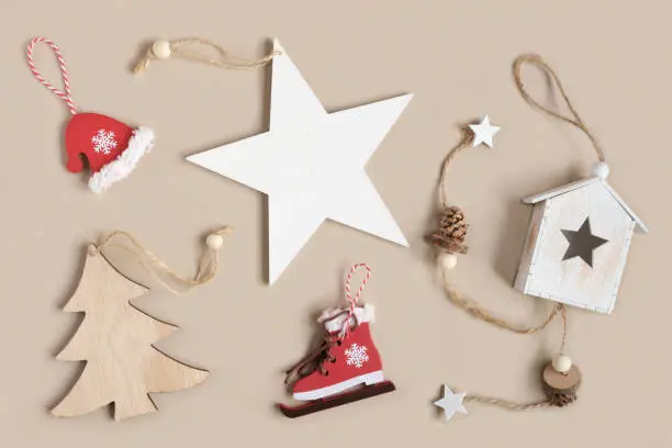 Photo of Eco christmas toys. Wooden christmas star decoration on neutral beige background with copy space. Eco friendly Christmas decor for home, zero waste concept. Composition in eco-style. Top view