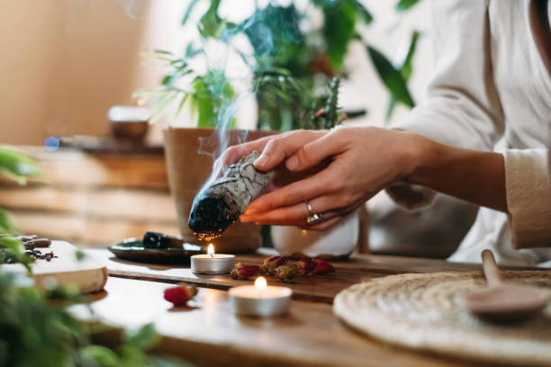 istock Hands burning white sage for ancient spiritual ritual 1354854628