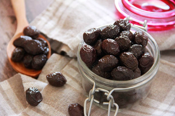 istock Black olives in glassware and wooden spoon 1354855689
