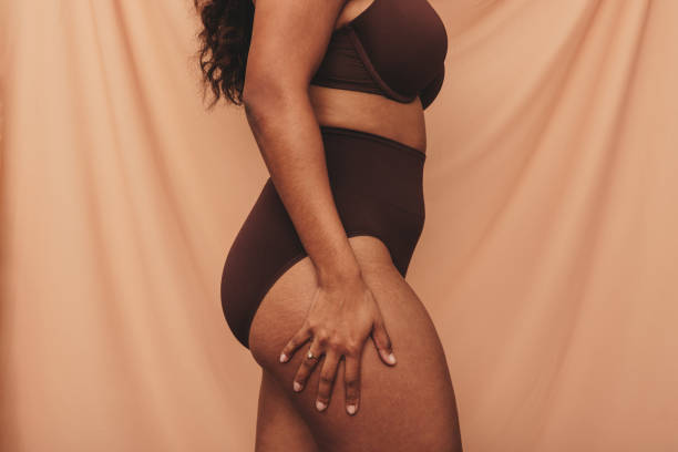 istock Anonymous young woman standing in brown underwear 1354855818