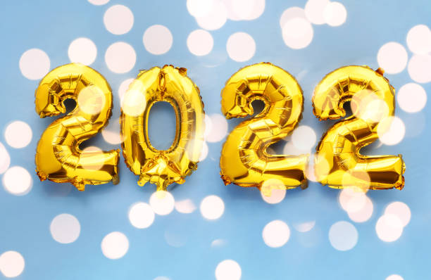 istock 2022 new year foil balloon numbers on sparkling blue background 1354855833