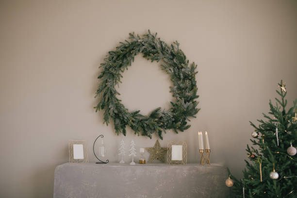 istock Christmas handmade wreath hanging on grey wall under the fireplace. 1354856617