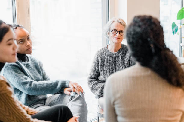 istock Multiracial women sitting in support group session 1354857384