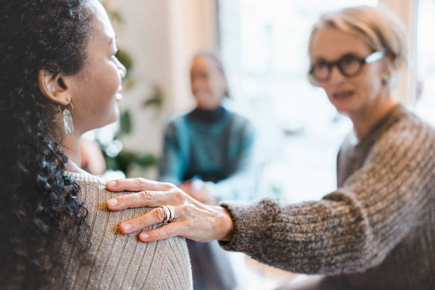 Therapist giving psychological support to a woman during therapy session