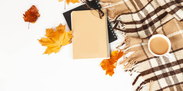 istock Autumn composition. Cup of coffee, glasses, plaid, notepad, autumn leaves on white background. Flat lay, top view, copy space. Concept of hot drinks in autumn 1354857847