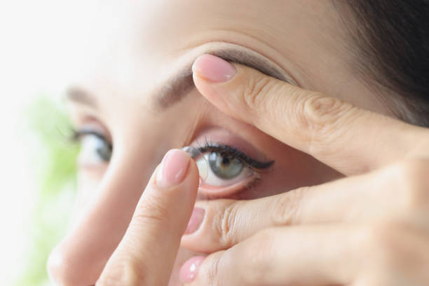 istock Woman puts on long-term soft contact lenses closeup 1354857859