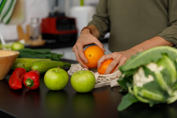 Unpacking oranges and other fruit and veg from a reusable, mesh bag