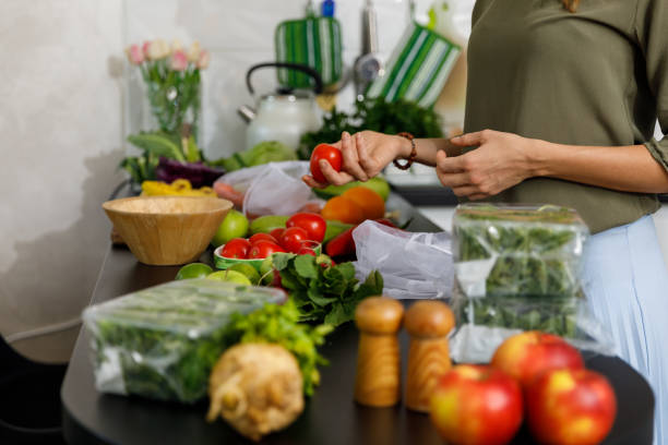 istock Copy space shot of unrecognizable woman unpacking fresh tomatoes 1354858183
