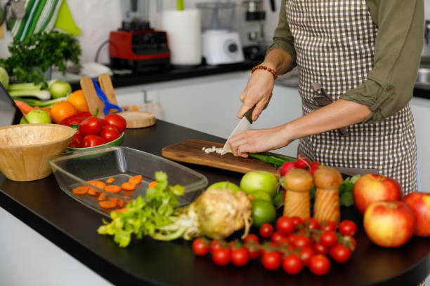 istock Woman finely chopping a scallion in her zero waste kitchen 1354858762