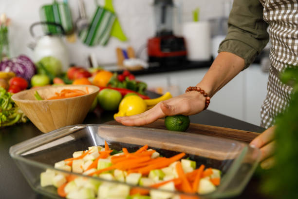 istock Woman rolling a lime before cutting it and squeezing the juice out 1354858773