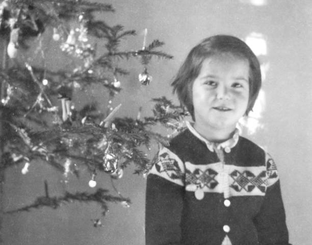 istock Little Girl under Christmas Tree in 1954. 1354858867